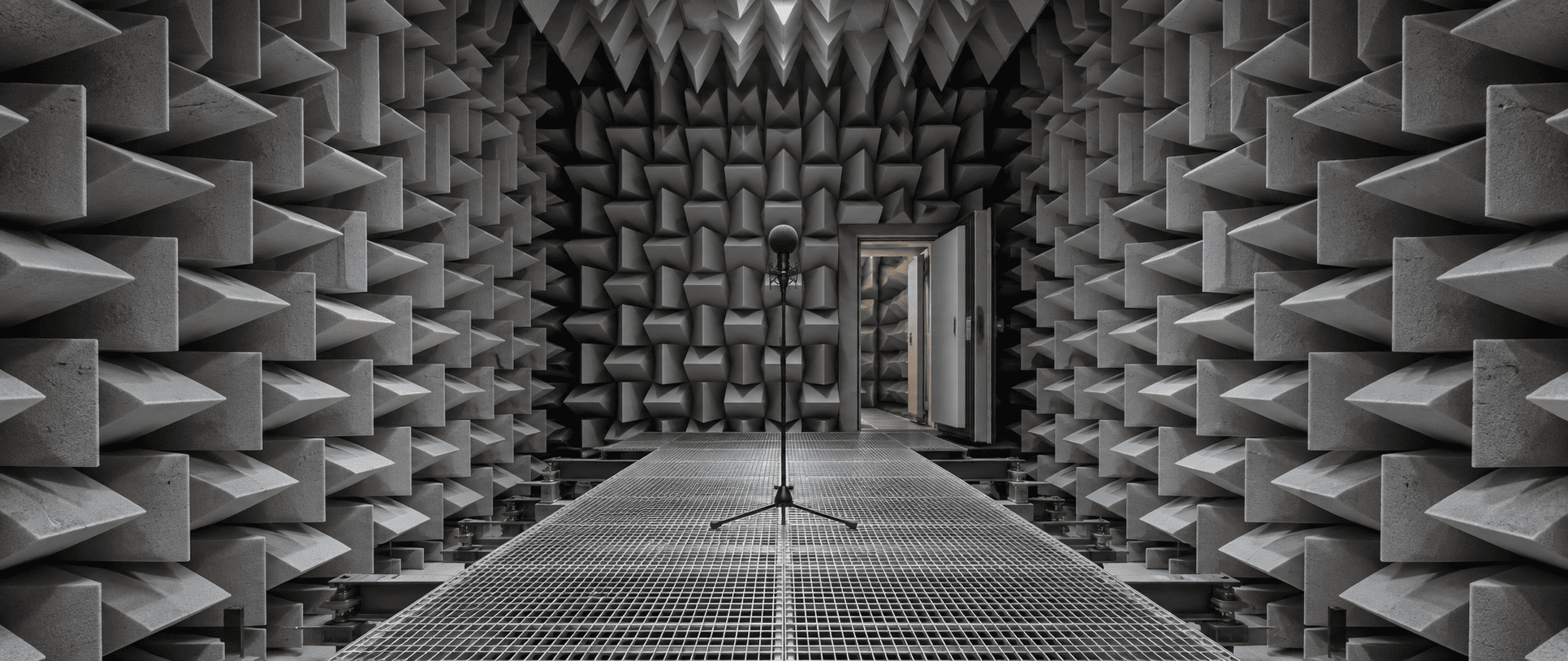 Deep acoustic foam wedges lining the walls and ceiling of an anechoic test chamber